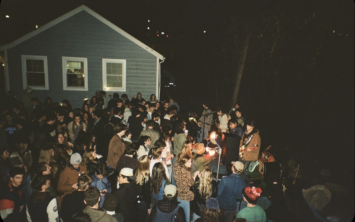 Packed backyard crowd watching a Beatline band play